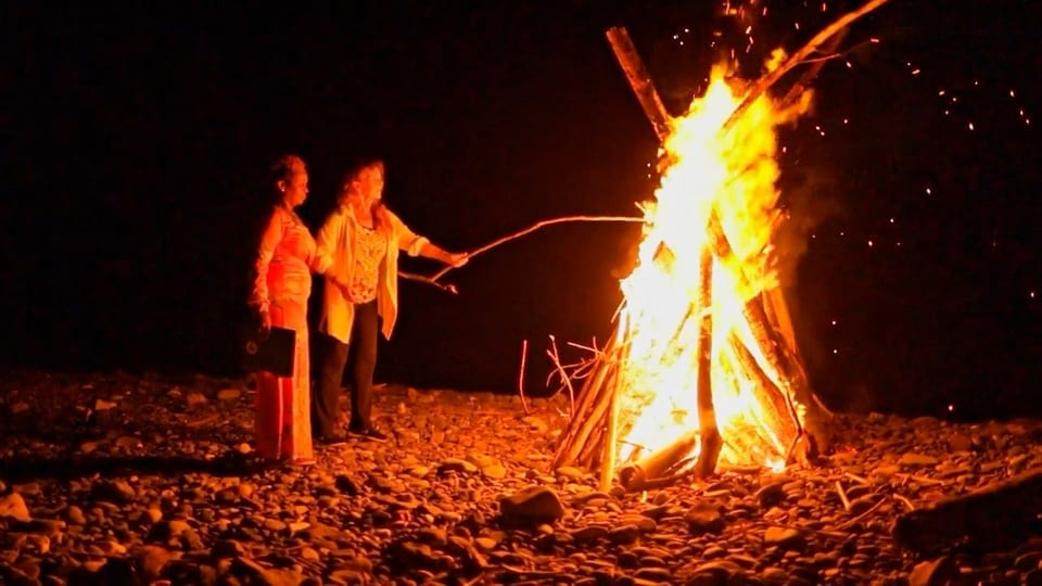 Participants beside a beach fire during the approved previous retreat