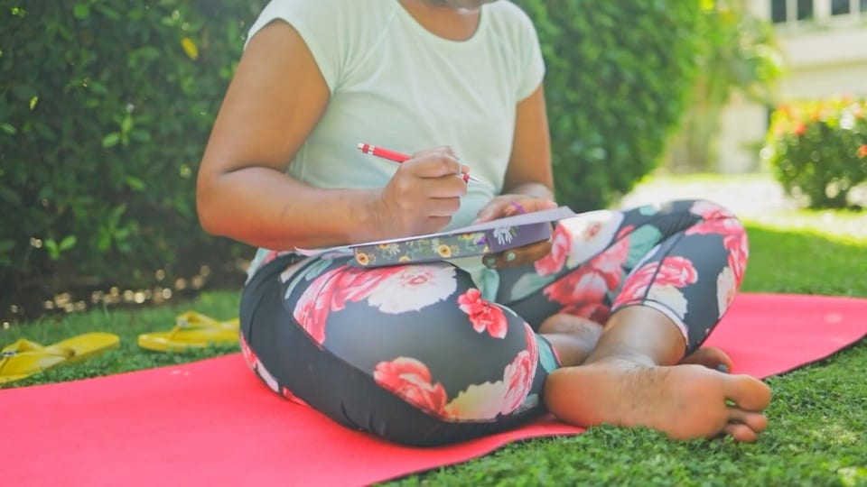 A quiet moment of journaling on a retreat mat